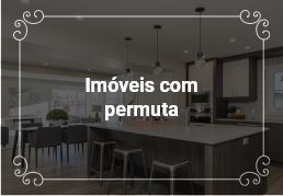 Área de lazer fechada, com várias mesas e cadeiras, cozinha completa.